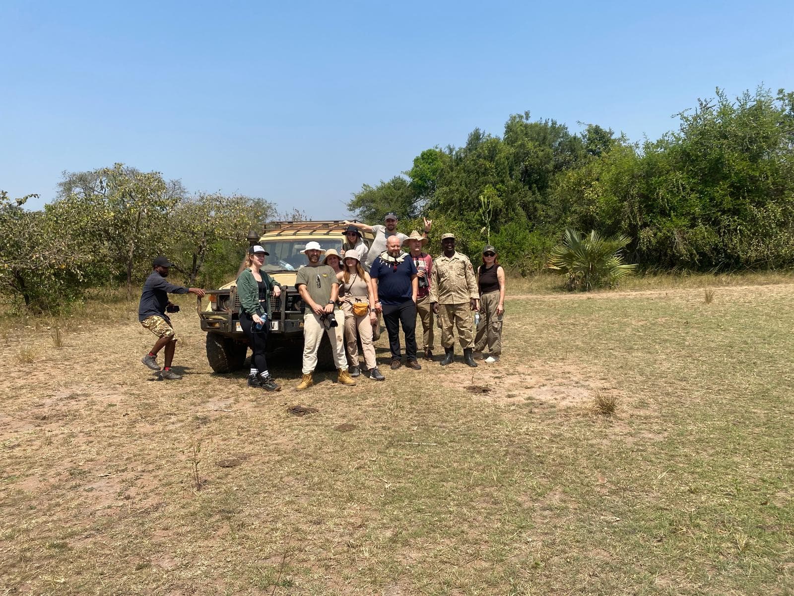 Tourisits pose for a photo after rhino tracking 